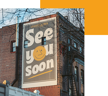 Signage outside of George's Deli that reads, "See you soon."