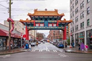 A colorful Chinese-style gate stands over a busy city street.