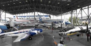 Aviation museum hangar displaying various historic airplanes.