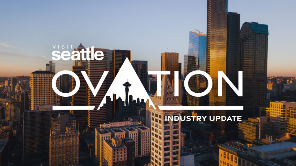 Aerial view of downtown Seattle at sunset with tall buildings. The text “Visit Seattle Ovation Industry Update” is overlaid, featuring the Space Needle icon in the word “Ovation.”.