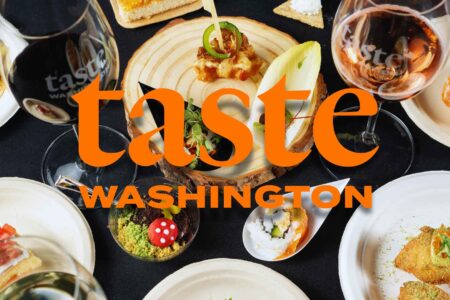 An overhead view of assorted gourmet appetizers on white plates with glasses of red and rosé wine. The words 