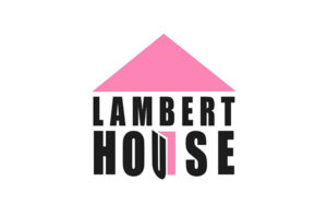 Logo with a pink triangle roof above the words "Lambert House" in black, with the "U" in "House" shaped like an open door and highlighted in pink. White background.