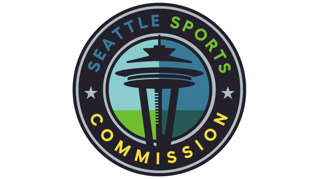 Logo of the Seattle Sports Commission, featuring the Space Needle in the center with a blue and green background, surrounded by a dark circular border with stars and the organization’s name in blue, green, and yellow letters.